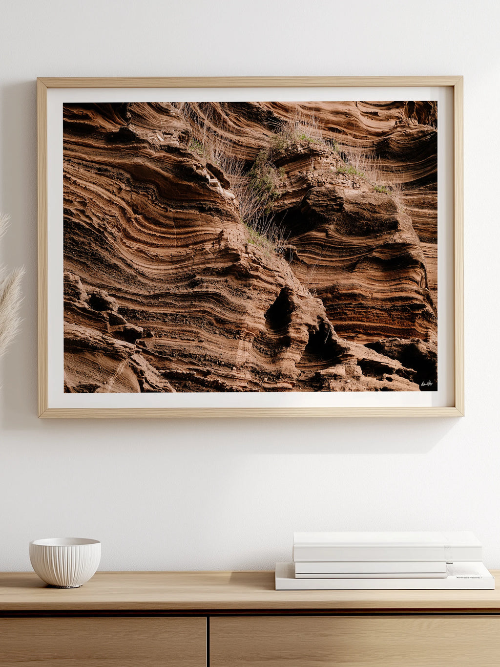 Lake Purrumbete Volcanic Rock Face framed print hanging above a low timber sideboard