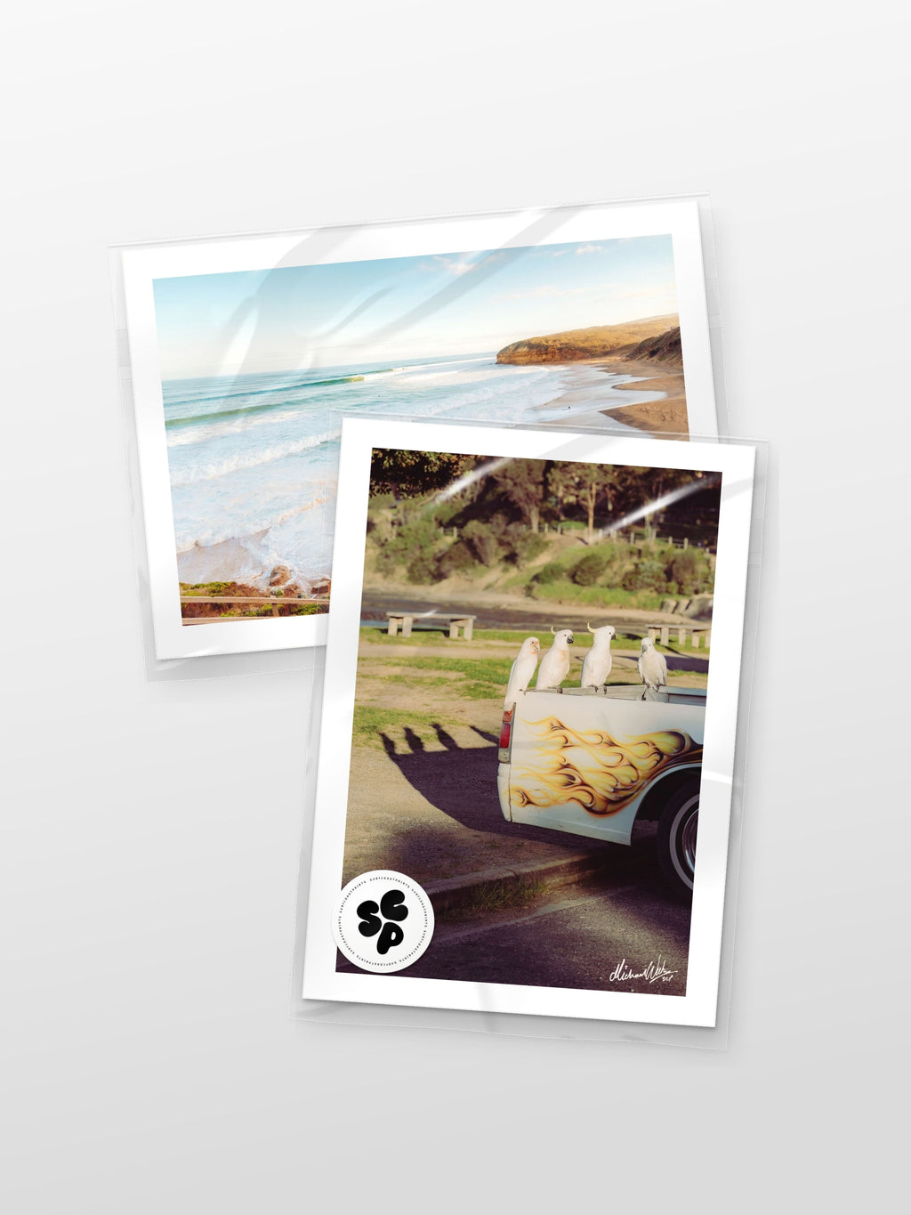 Surf Coast Prints sample pack: two 6x4 inch photo prints, Bells Beach at Sunset and Lorne Cockatoos, Corellas and Cars, in protective sleeves