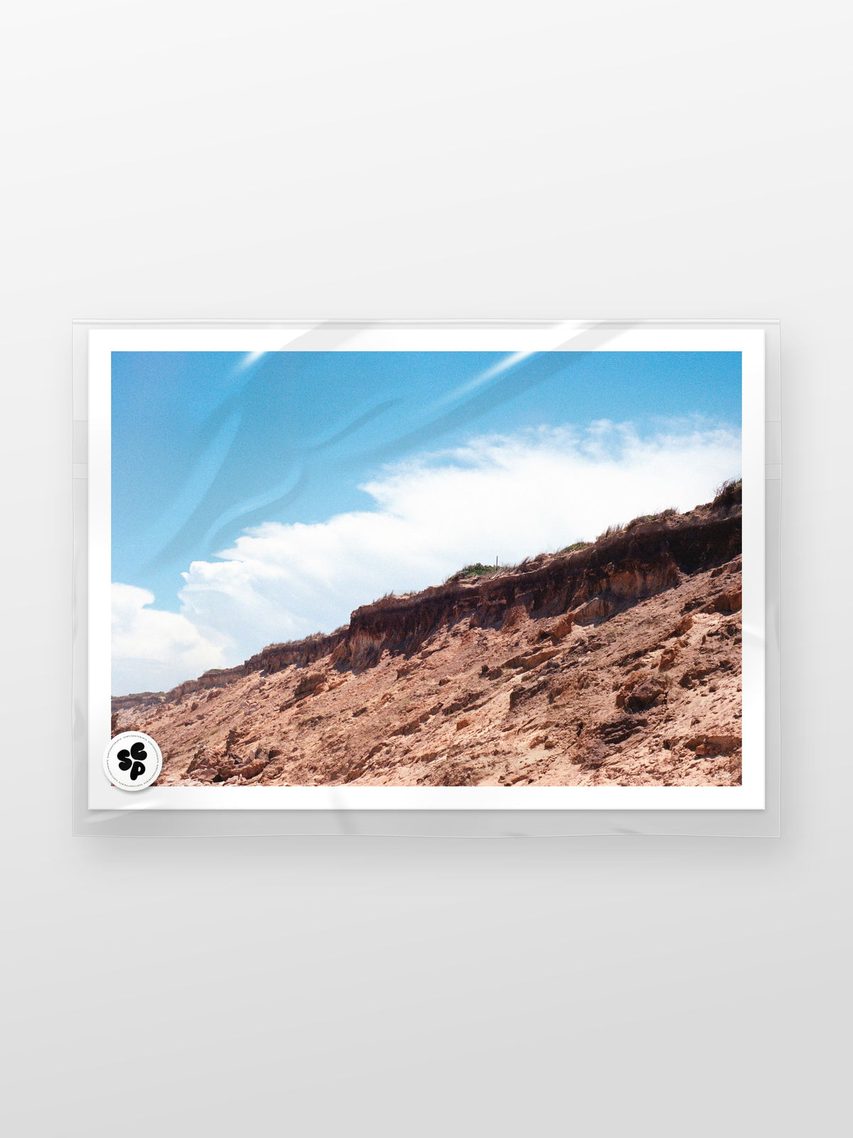 Thirteenth Beach Cliffs, Rocks and Clouds Landscape print in a protective sleeve