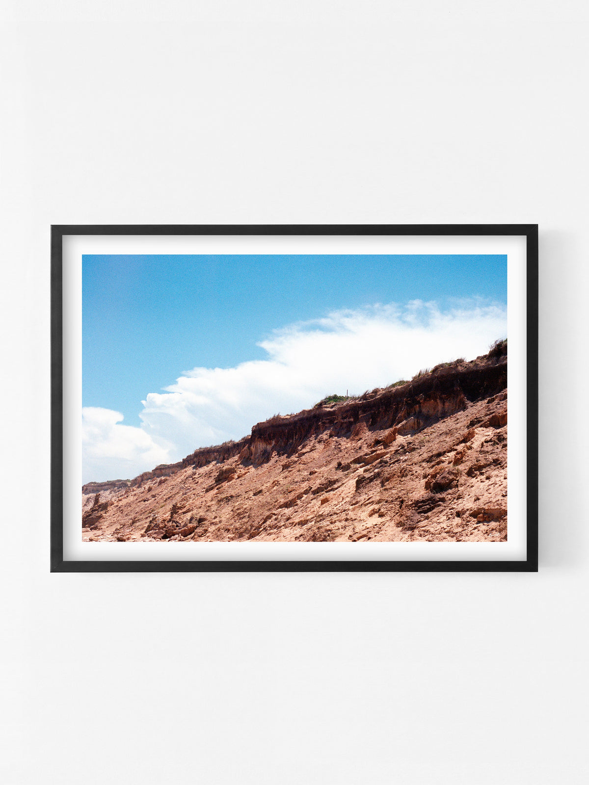 Thirteenth Beach Cliffs, Rocks and Clouds Landscape print in a black shadowbox frame